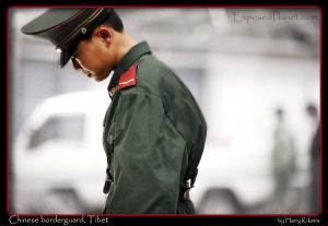 Chinese borderguard thinking, friendship bridge, border Tibet-Nepal. (c) Harry Kikstra, ExposedPlanet.com Chinese borderguard thinking, friendship bridge, border Tibet-Nepal. (c) Harry Kikstra, ExposedPlanet.com